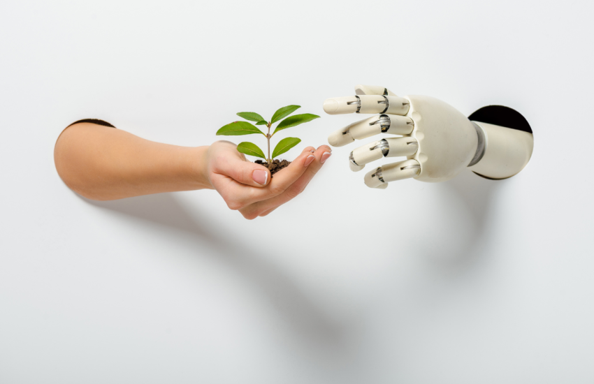 Mano y robot intercambiando planta